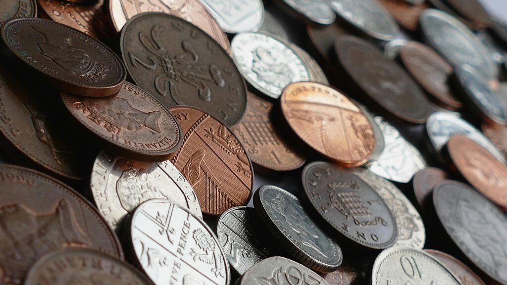 A close-up image of various world coins in a pile, highlighting different currencies.